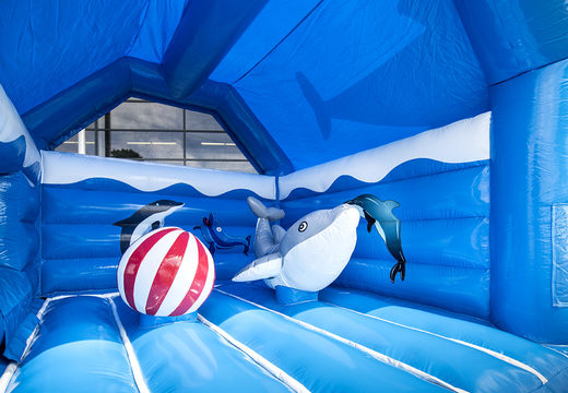 Buy indoor multifun blue bouncy castle with slide in a dolphin theme with large 3D objects on top for children. Order bouncy castles online at JB Inflatables UK