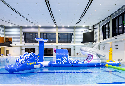 Get an airtight 13 meter long inflatable shark themed swimming pool obstacle course in a unique design with funny 3D objects and no less than 2 slides for both young and old. Order inflatable obstacle courses online now at JB Inflatables America