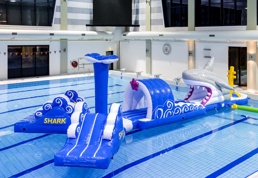 Inflatable 13 meter long shark run swimming pool obstacle course in a unique design with funny 3D objects and no less than 2 slides for both young and old. Order inflatable obstacle courses online now at JB Inflatables America