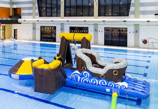 Buy an airtight pirate inflatable play island with a vine, climbing tower, round slide and obstacles for both young and old. Order inflatable water attractions now online at JB Inflatables America