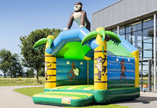 Buy a standard jungle bouncy castle for children in striking colors with a large 3D object in the shape of a gorilla on the top. Order bouncy castles online at JB Inflatables UK