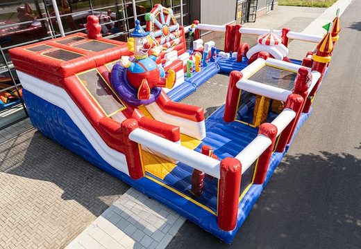 Circus themed inflatable bouncy castle with multiple slides and all kinds of fun obstacles with prints that match the theme for kids. Order bouncy castles online at JB Inflatables UK