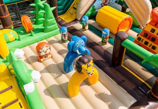 Jungle 20 meter bouncy castle with slides, obstacles with fun jungle-themed prints for kids. Order bouncy castles online at JB Inflatables UK