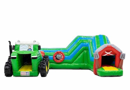 Buy a large tractor bouncy castle with obstacles, a climbing slope and a slide for children. Order bouncy castles online at JB Inflatables UK