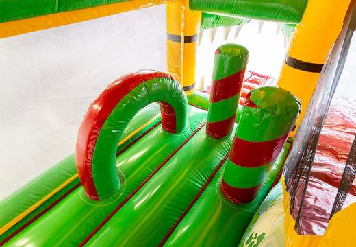 Crocodile-themed bouncy castle with a slide and 3D objects for children. Order bouncy castles online at JB Inflatables UK