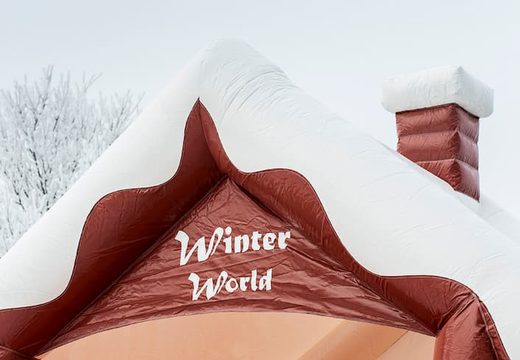Skihut winterworld bounce house with a 3D chimney at the top for children. Bounce houses for sale online at JB Inflatables UK