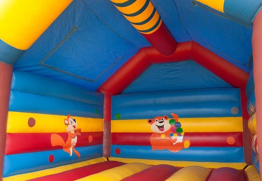Big super bounce house covered with cheerful animations in monkey theme for children. Order bounce houses online at JB Inflatables UK