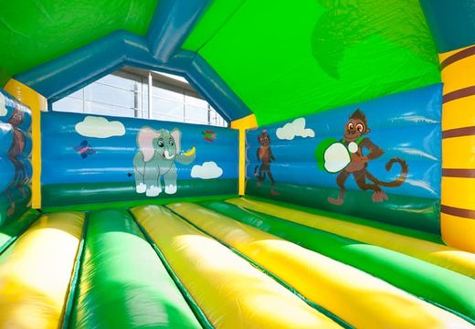 Big super bounce house covered with cheerful animations in Jungle theme for children. Order bounce houses online at JB Inflatables UK