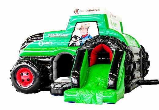 Maatwerk springkussen in de vorm van een trekker met een glijbaan