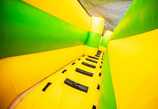 Super grote opblaasbare glijbaan van 46 meter lang bestellen in het geel met groen